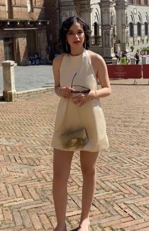 Ein ärmelloses cremefarbenes Halfterkleid mit einem montierten Oberteil und einem ausgestellten Rock, perfekt für Abschlusszeremonien.